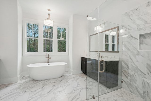 bathroom with baseboards, a freestanding bath, a stall shower, marble finish floor, and vanity