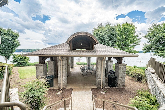 view of patio with a water view