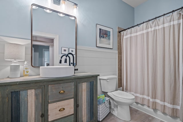 full bathroom featuring vanity, wood-type flooring, shower / bath combination with curtain, and toilet