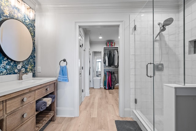 bathroom with vanity, hardwood / wood-style floors, crown molding, and an enclosed shower