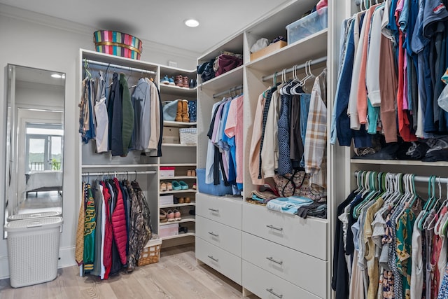 walk in closet featuring light hardwood / wood-style flooring