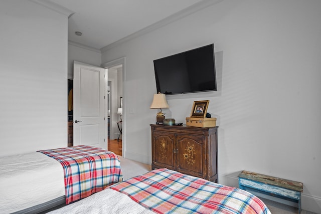 bedroom with light carpet and ornamental molding