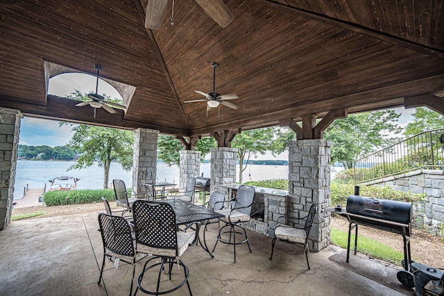 view of patio / terrace with a water view, ceiling fan, and area for grilling