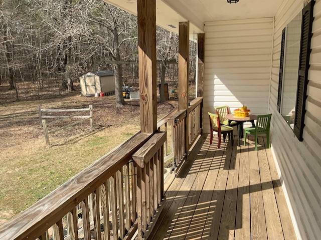 wooden terrace featuring a storage shed