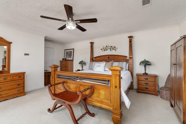 carpeted bedroom featuring ceiling fan, ornamental molding, and a textured ceiling