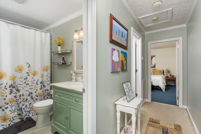 bathroom featuring crown molding, vanity, toilet, and a textured ceiling