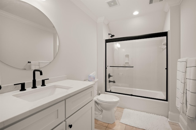 full bathroom featuring combined bath / shower with glass door, tile patterned flooring, vanity, ornamental molding, and toilet