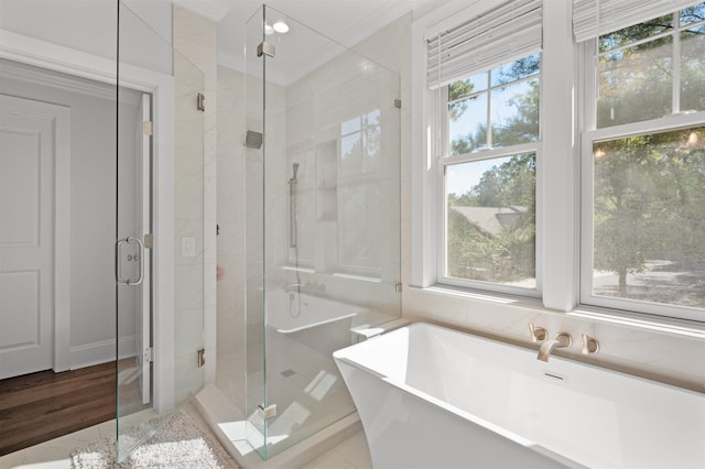 bathroom featuring crown molding and shower with separate bathtub