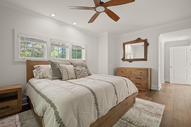 bedroom featuring crown molding, ceiling fan, and light hardwood / wood-style flooring