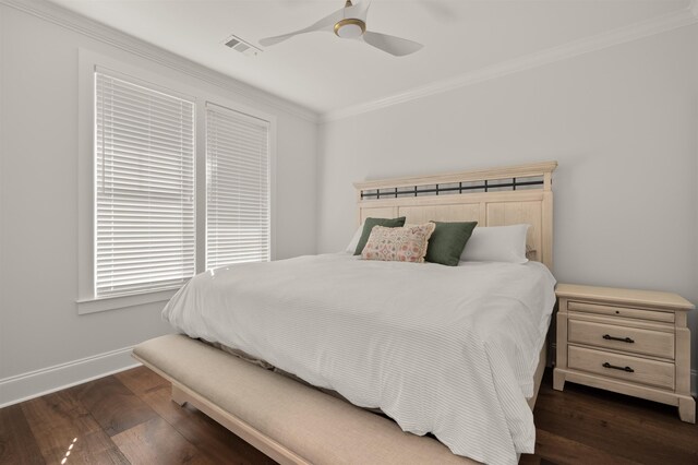 bedroom with ornamental molding, dark hardwood / wood-style floors, and ceiling fan