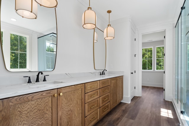 bathroom featuring vanity, an enclosed shower, crown molding, and wood-type flooring