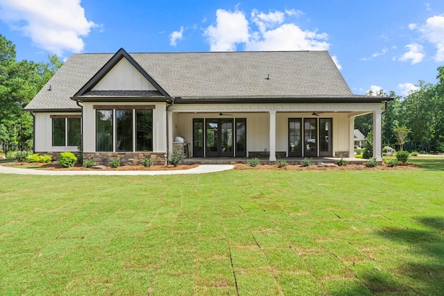 rear view of house with a yard, ceiling fan, and french doors