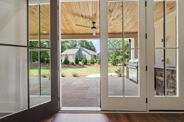 doorway with wooden ceiling and ceiling fan