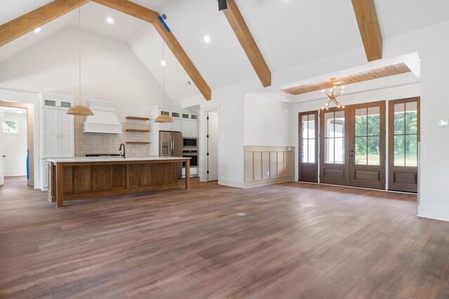 unfurnished living room with beamed ceiling, dark wood-type flooring, and high vaulted ceiling