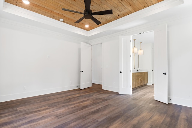 unfurnished bedroom featuring dark hardwood / wood-style floors, sink, wood ceiling, a tray ceiling, and crown molding