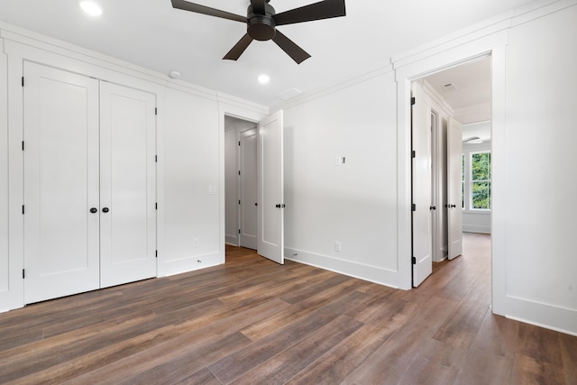 unfurnished bedroom featuring crown molding, ceiling fan, and dark hardwood / wood-style flooring