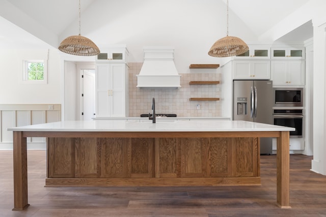 kitchen featuring a spacious island, white cabinetry, appliances with stainless steel finishes, and custom range hood