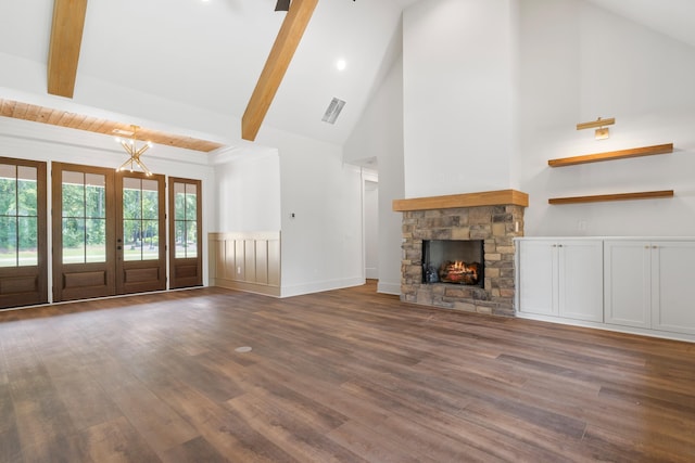 unfurnished living room with french doors, beam ceiling, high vaulted ceiling, dark hardwood / wood-style flooring, and a fireplace