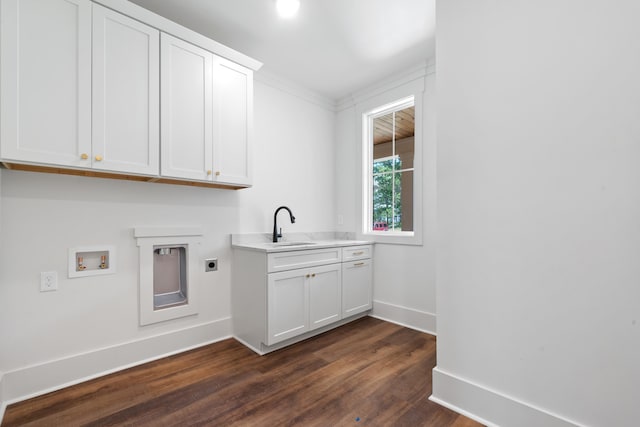 laundry room featuring dark hardwood / wood-style floors, sink, cabinets, washer hookup, and electric dryer hookup