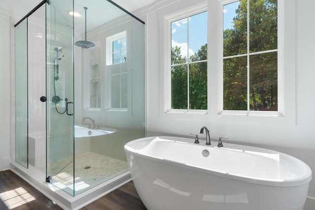 bathroom featuring hardwood / wood-style flooring and independent shower and bath