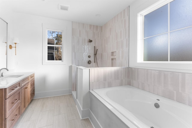 2050 Osprey Poynte, Greensboro, GA 30642 - bathroom with a garden tub, vanity, and tiled shower