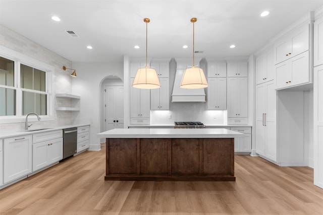 2050 Osprey Poynte, Greensboro, GA 30642 - kitchen with appliances with stainless steel finishes, light wood-style floors, arched walkways, light countertops, and recessed lighting