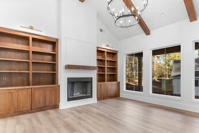 2050 Osprey Poynte, Greensboro, GA 30642 - unfurnished living room featuring a chandelier, high vaulted ceiling, a large fireplace, light wood-style flooring, and beamed ceiling