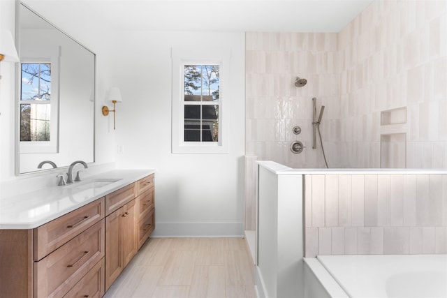 2050 Osprey Poynte, Greensboro, GA 30642 - full bathroom with vanity, tiled shower, plenty of natural light, and a tub to relax in
