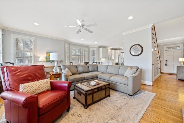 living room featuring crown molding, recessed lighting, light wood-style floors, and a healthy amount of sunlight