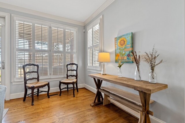 home office featuring crown molding, light wood-style floors, and baseboards