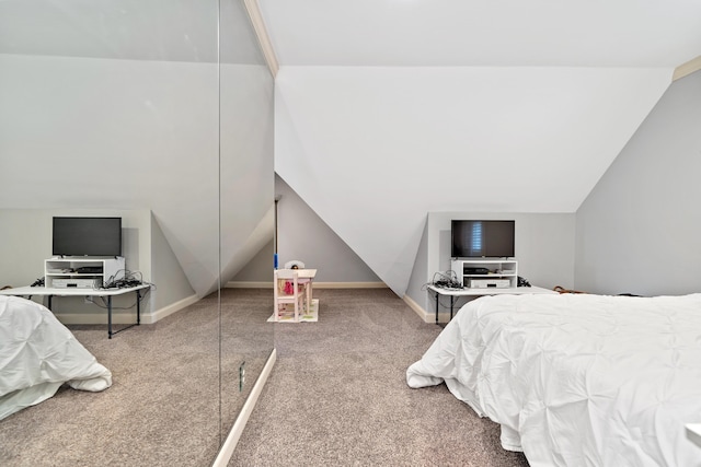 bedroom with vaulted ceiling, carpet, and baseboards