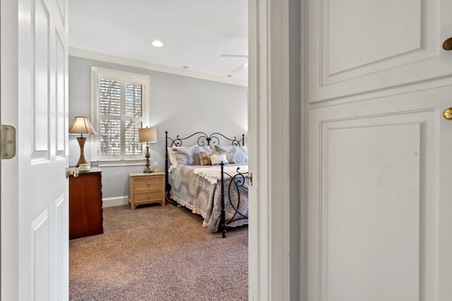 carpeted bedroom featuring recessed lighting and ornamental molding