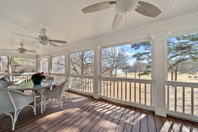 sunroom / solarium with a ceiling fan