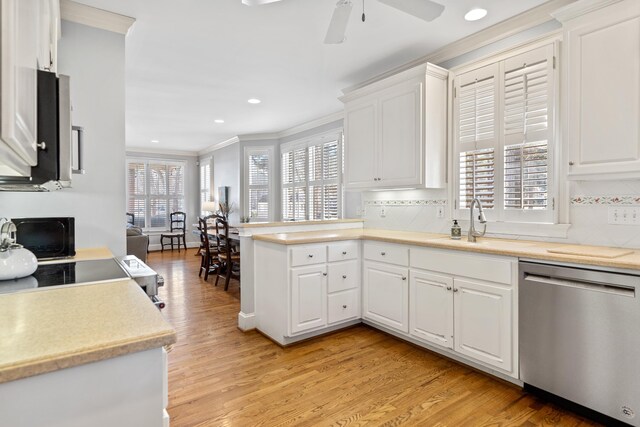 kitchen featuring appliances with stainless steel finishes, a peninsula, crown molding, and white cabinets