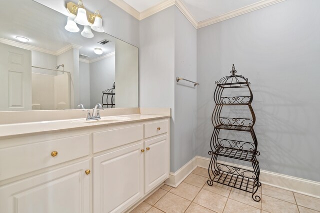 bathroom featuring tile patterned floors, visible vents, crown molding, baseboards, and vanity