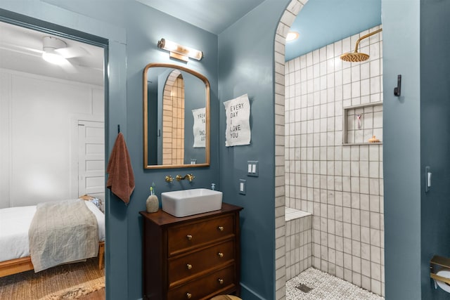 ensuite bathroom featuring vanity, ensuite bath, and walk in shower