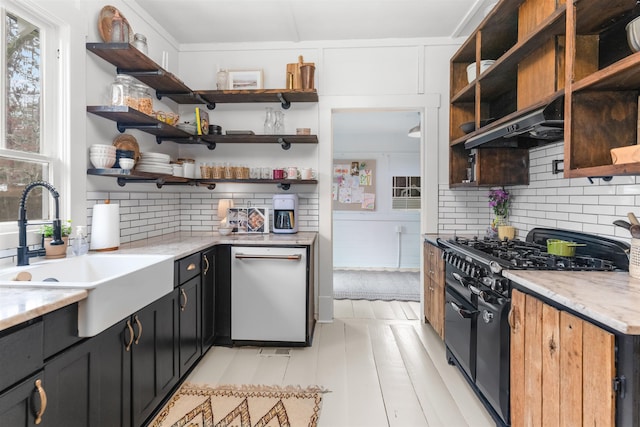 kitchen featuring open shelves, double oven range, under cabinet range hood, a sink, and dishwashing machine