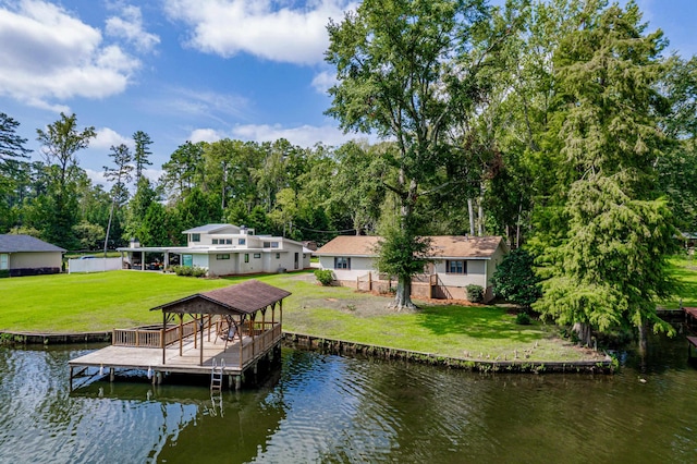 dock area with a yard and a water view