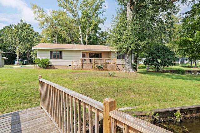 back of property with a wooden deck, a yard, and crawl space