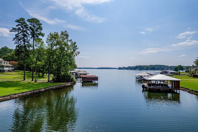 water view featuring a boat dock, fence, and boat lift