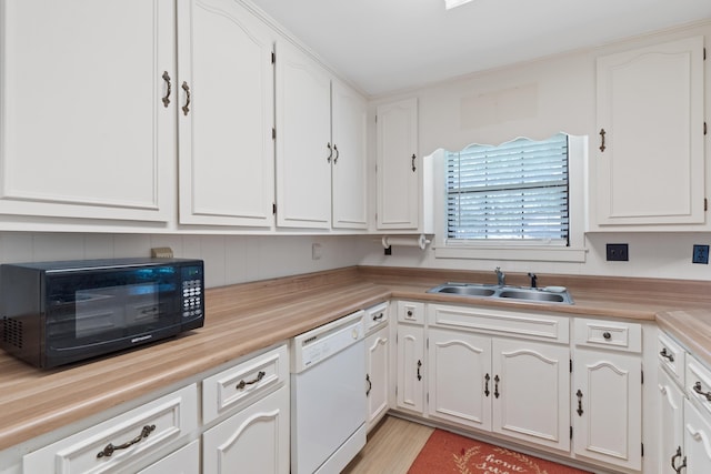 kitchen featuring a sink, light countertops, white cabinetry, and dishwasher