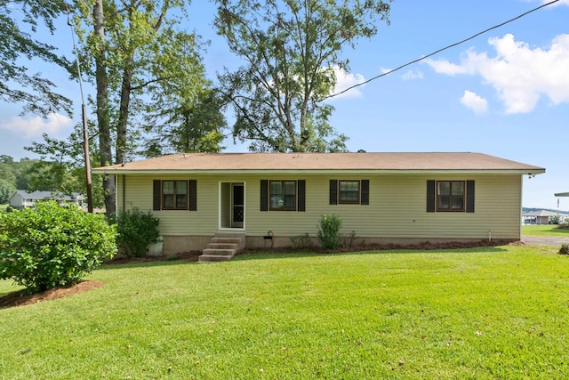 back of property with a lawn