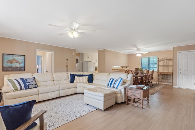 living area featuring ceiling fan and light wood finished floors