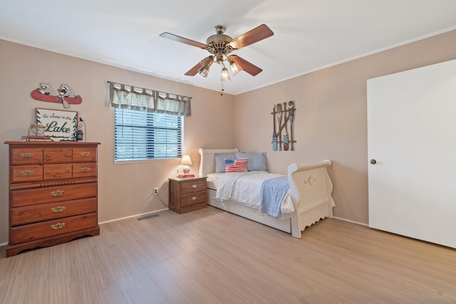 bedroom featuring baseboards, ceiling fan, and wood finished floors