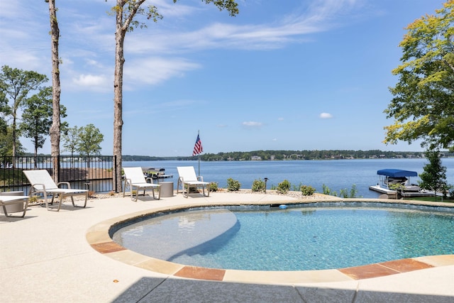 view of pool with a water view and a patio area