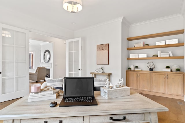 office space featuring ornamental molding and light hardwood / wood-style floors