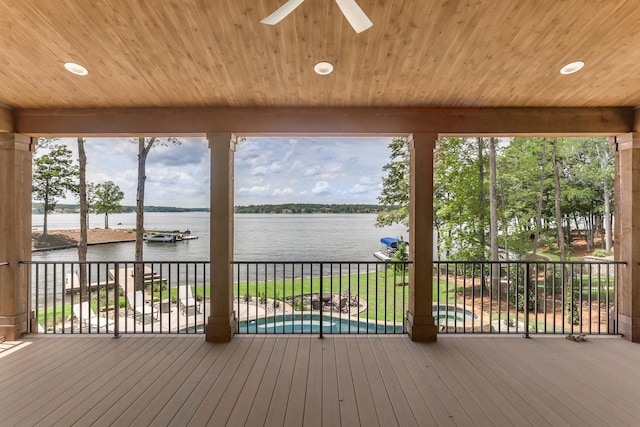 wooden terrace with ceiling fan and a water view