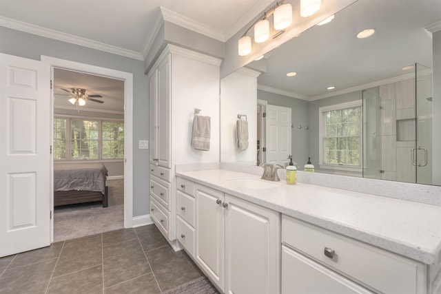 bathroom featuring tile patterned flooring, vanity, a shower with door, and ornamental molding