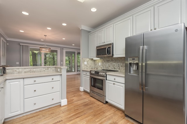 kitchen with tasteful backsplash, ornamental molding, stainless steel appliances, and white cabinets