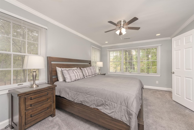 carpeted bedroom featuring crown molding and ceiling fan